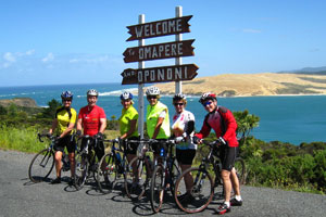 The cycling group gathers at the entrance to Hokianga Harbour after a thrilling ride through Waipoua Forest. Photo / Margie Elley-Brown