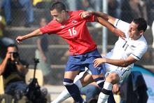 Leo Bertos (right) battles it out with Chile's Fabian Orellana, during their practice match. Photo / Brett Phibbs Leo Bertos (right) battles it out with Chile's Fabian Orellana, during their practice match. Photo / Brett Phibbs