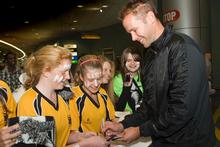 Mark Paston signs autographs for members of Massey High School Girls' First XI at Auckland Airport yesterday. Photo / Paul Estcourt Mark Paston signs autographs for members of Massey High School Girls' First XI at Auckland Airport yesterday. Photo / Paul Estcourt
