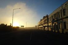 Sunrise hits the main street of Bluff. Photo / Dean Purcell Sunrise hits the main street of Bluff. Photo / Dean Purcell