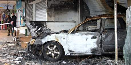 The burnt out shell of a liquor store and stolen car following a ram raid at the Northcrest shops in Manurewa, Auckland. Photo / NZPA The burnt out shell of a liquor store and stolen car following a ram raid at the Northcrest shops in Manurewa, Auckland. Photo / NZPA