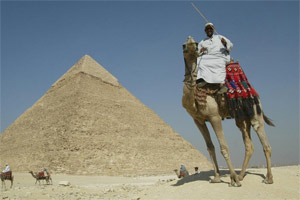 A camel driver touts for business at the great pyramids of Giza near Cairo. Photo / Alan Gibson