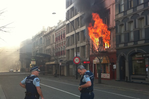 A building bursts into flames in central Cristchurch. Photo / Simon Baker.