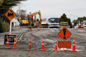 Road workers begin the task of cleaning up debris. Photo / Getty Images