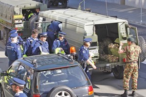 Police officers are loaded into NZ Army vehicles outside the Christchurch central Pplice station, bound for Burnham military camp. Photo / Sarah Ivey