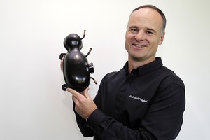 Fisher & Paykel chief executive Stuart Broadhurst with one of the new fridge compressors. Photo / NZPA