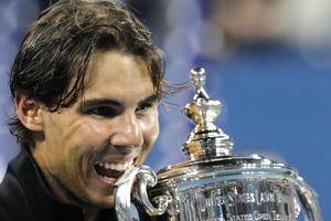 Rafael Nadal of Spain bites his trophy after beating Novak Djokovic. Photo / AP