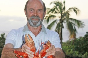 Jim Eagles with a cooked coconut crab on Niue. Photo / Jim Eagles