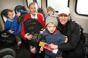 Leah Robinson with her young family Noah (7, left) Eva-Rae (12) and 4-year-old twins Will (front) and Jude on the 8.15am train from Onehunga that left from the newly opened platform yesterday. Photo / Greg Bowker