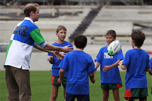 Prince William throws a rugby ball around with some kids at Eden Park. Photo / Sarah Ivey