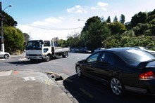The black car (right) obeying the 'right hand rule' as it gives way to oncoming traffic (truck) turning right. Photo / Sarah Ivey The black car (right) obeying the 'right hand rule' as it gives way to oncoming traffic (truck) turning right. Photo / Sarah Ivey
