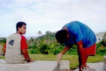 Boys add finishing touches to the newly tiled graves of tsunami victims, in preparation for a memorial on the 29th. Photo / Cherelle Jackson Boys add finishing touches to the newly tiled graves of tsunami victims, in preparation for a memorial on the 29th. Photo / Cherelle Jackson