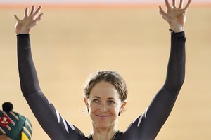 Joanne Kiesanowski of New Zealand waves to the crowd on the dias following her silver medal in the Womens Scratch race. Photo / Getty Images