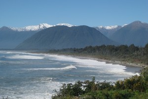 The sweep of Jackson Bay looking north towards Haast with the Southern Alps in the background. Photo / Jill Worrall