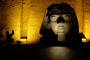 A tourist takes photos at the Temple of Luxor. Photo / Alan Gibson