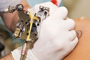 A Queensland man is facing assault charges after tattooing a 40cm penis and a crass slogan on his mate's back. Photo / Thinkstock