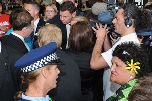 Police speak to a Matt McCarten candidate supporter Rima Taraia who was attempting to yell down Prime Minister John Key as he visited the North City shopping mall, Porirua. Photo / NZPA