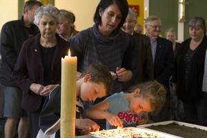 Church goers light candles during a special service after the first Pike River blast. Photo / Mark Mitchell
