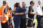 Grey District Mayor Tony Kokshoorn hugs a police officer as distraught family members leave after being told of the second blast. Photo / Mark Mitchell Grey District Mayor Tony Kokshoorn hugs a police officer as distraught family members leave after being told of the second blast. Photo / Mark Mitchell