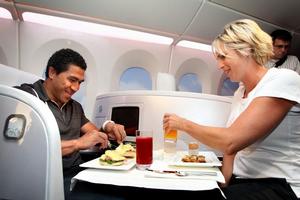 All Black Mils Muliaina and Olympic gold-medal cyclist Sarah Ulmer sample Air New Zealand's new menu. Photo / Natalie Slade