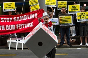 Simon Oosterman rolls the dice in protest against the Trans-Pacific Partnership Agreement. Photo / NZPA