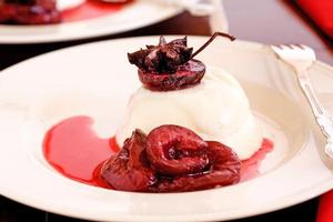 Panna cotta with star anise plums. Photo / Babiche Martens