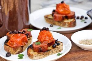 Chorizo, tomatoes, currants and oregano on toast. Photo / Babiche Martens