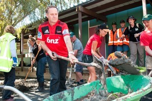 Prime Minister John Key helps out the Farmy Army volunteers at Linwood College today. Photo / NZPA