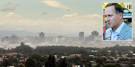 Christchurch battles strong winds and dust from the silt caused by liquefaction following last week's quake and inset, John Key. Photo / Brett Phibbs Christchurch battles strong winds and dust from the silt caused by liquefaction following last week's quake and inset, John Key. Photo / Brett Phibbs