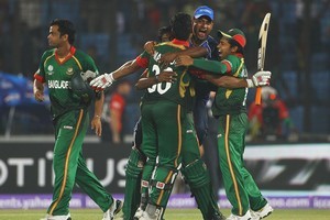 Mahmudullah of Bangladesh is congratulated by his team mates, after hitting the winning runs against England. Photo / Getty Images