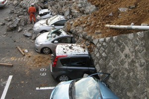 Vehicles were crushed by a collapsed wall at a carpark in Mito city, Ibaraki prefecture, after the massive magnitude 8.9 earthquake rocked Japan, unleashing a tsunami across the Pacific. Photo / AFP