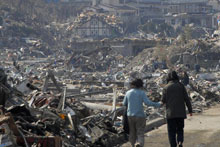 A couple walk along the rubble at a residential area in Onagawa, Miyagi Prefecture, northern Japan after Friday's quake. Photo / AP A couple walk along the rubble at a residential area in Onagawa, Miyagi Prefecture, northern Japan after Friday's quake. Photo / AP