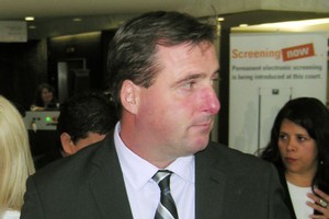 Policeman Martin Folan leaves the High Court acquitted of six assault charges. Photo / NZPA