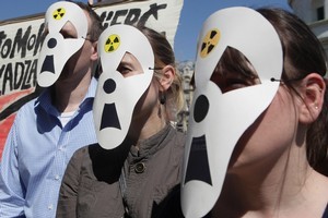 A handful of anti-nuclear activists protest in front of the Industry Ministry in Warsaw, Poland. Photo / AP