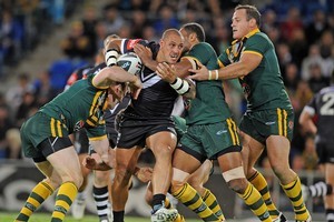 The Kangaroos defence piles in to stop a charging Jeremy Smith during last night's Anzac test. Photo / Getty Images