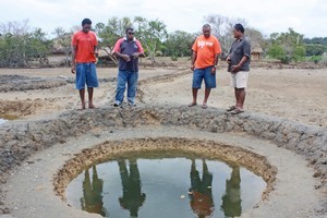 Michael Croker (at right) supervises traditional salt-making at Lomawai, Fiji. Photo / Jim Eagles
