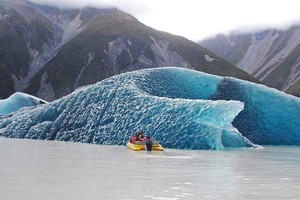 Blue ice is visible on a massive iceberg floating in Tasman Glacier's terminal lake after it rolled over yesterday morning. Photo / Magic Memories