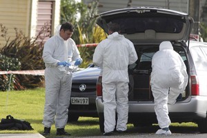 Police forensics officers at the siege scene. It will take take two to three days to complete the scene examination and reconstruct yesterday's events. Photo / Rob Tucker