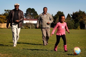 Four-year-old Ruhamah plays ball with her father, Zenebe Tsegi (left) and a family friend at Mt Roskill War Memorial Park. Photo / Sarah Ivey