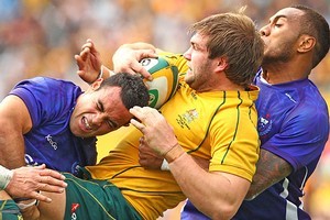 Ben McCalman of the Wallabies is tackled. Photo / Getty Images