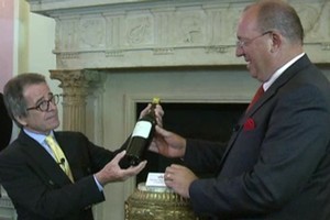 Christian Vanneque, is handed the bottle of 1811 Chateau d'Yquem, which he says he plans to open in five years' time. Photo / AFP