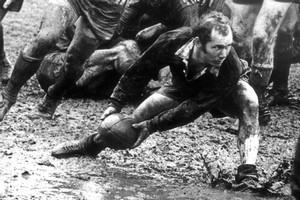 Sid Going gets the ball in atrocious conditions at Wellington's Athletic Park in the 1969 North Island vs South Island match. Photo / NZ Herald Archive