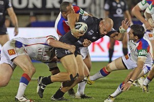 Sam Rapira of the Warriors fends off Ryan Stig of the Knights. Photo / Getty Images