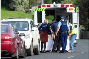 Emergency services treat a woman after a violent domestic incident in South Rd, Dunedin, last month. Photo / Craig Baxter