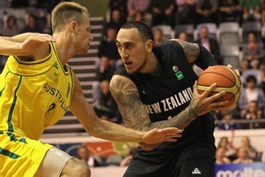 Leon Henry of New Zealand contests with Brad Newley of Australia. The Tall Blacks lost 91-78. Photo / Getty Images