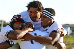 Vereniki Goneva, middle, of Fiji is congratulated by teammates after scoring against Namibia. Photo / Getty Images