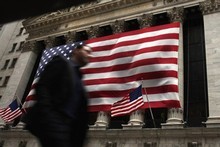 A man walks in front of the New York Stock Exchange in New York City, where stocks plunged on Friday. Photo / AFP 