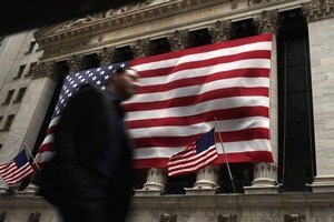 A man walks in front of the New York Stock Exchange in New York City, where stocks plunged on Friday. Photo / AFP