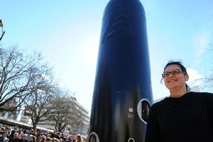 Rachel Rakena and her "towering black pou" artwork which is proving to be controversial in Dunedin. Photo / Otago Daily Times