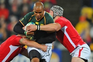 JP Pietersen of South Africa is tackled by Huw Bennett and Dan Lydiate of Wales. Photo / Getty Images